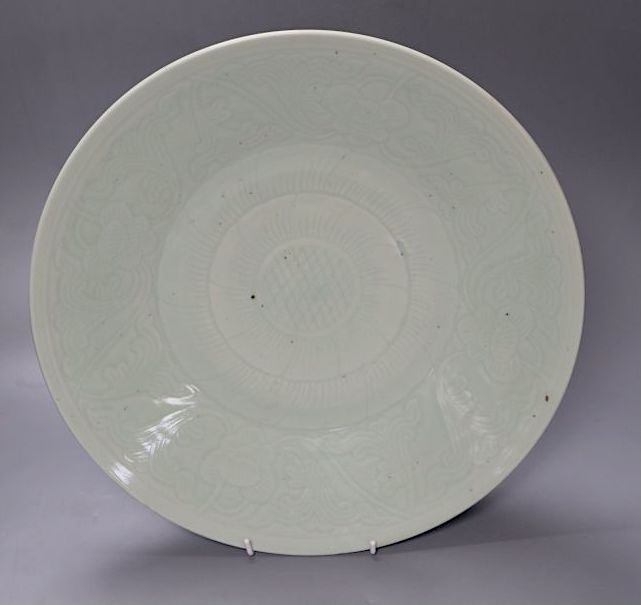 A 19th century Chinese carved celadon glazed charger, 38cm